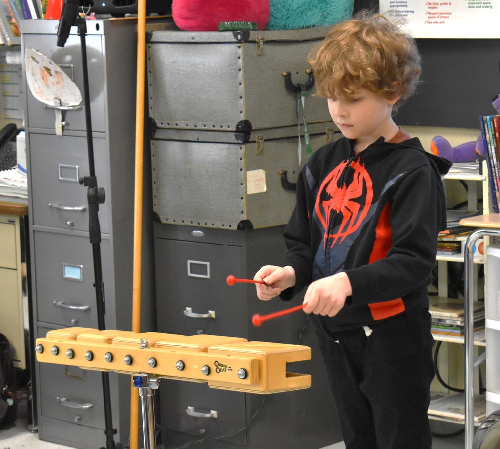 student in music class