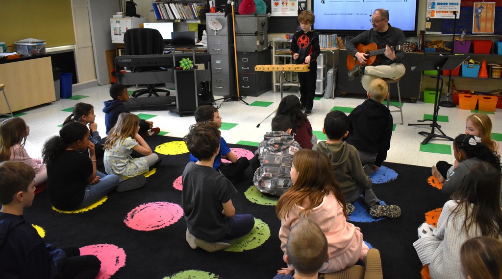 students and teacher in music class 