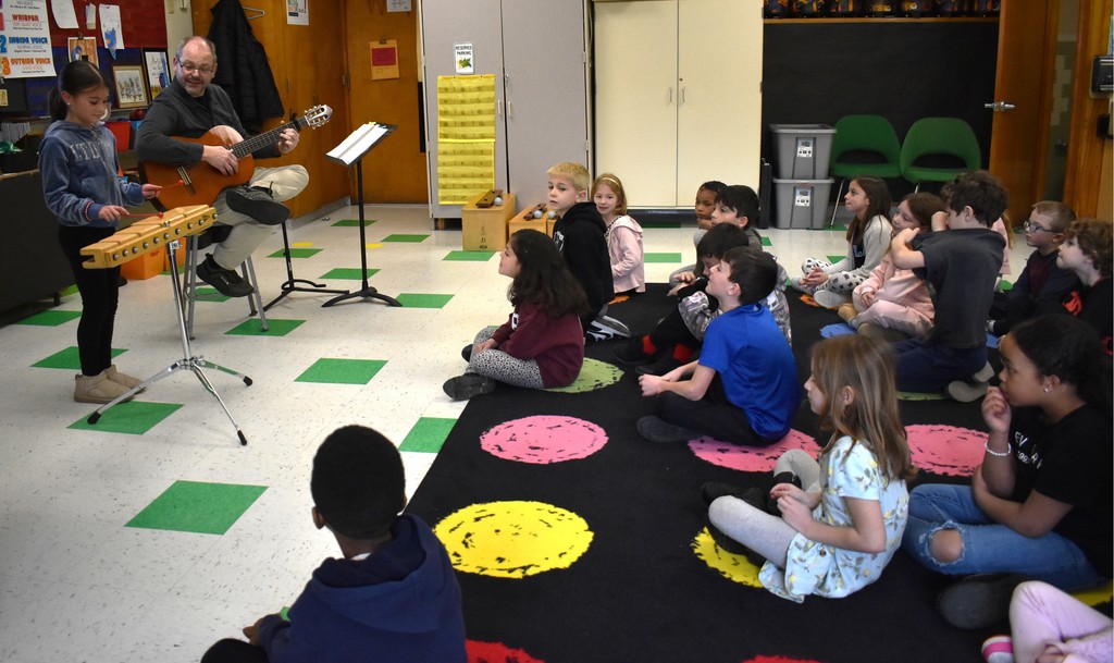 students and teachers in music class