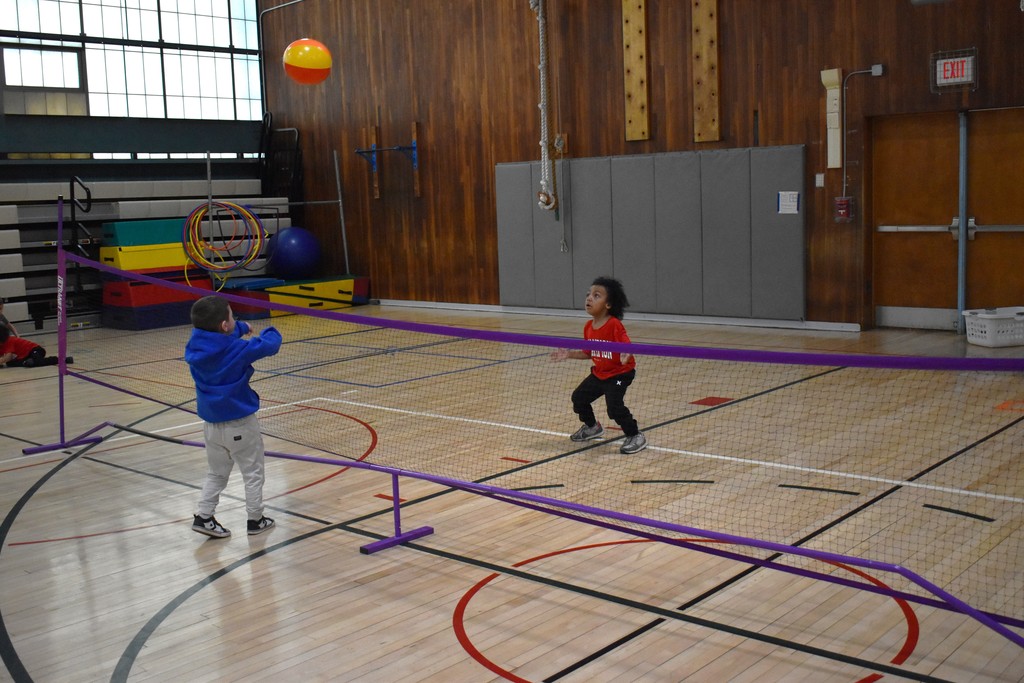 students and teacher in physical education class 