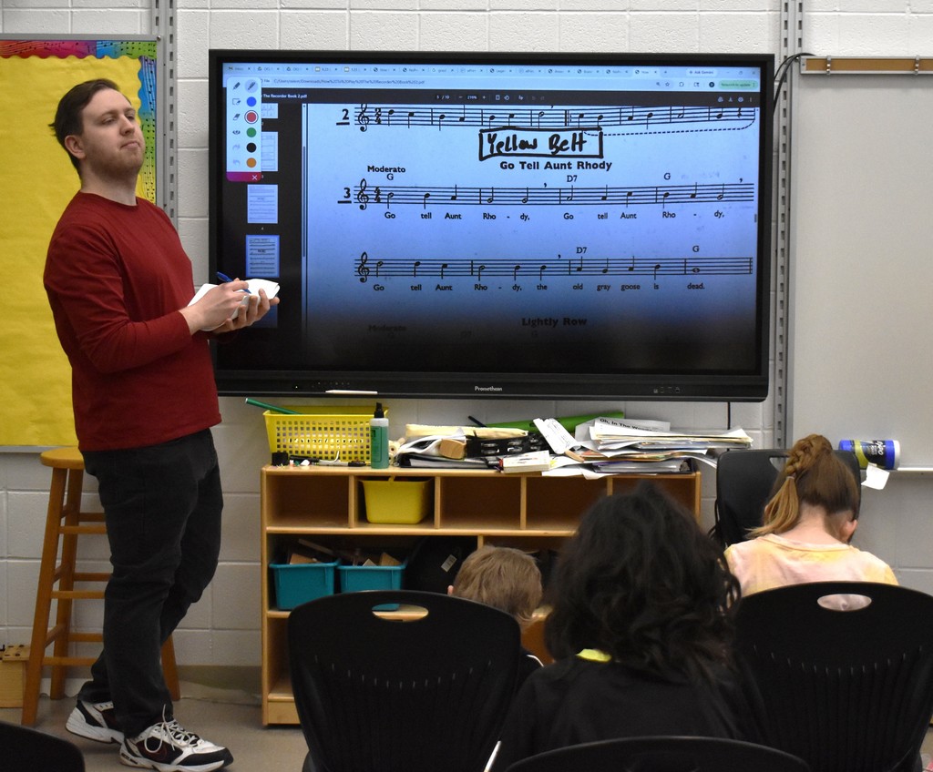 students and teacher in music class