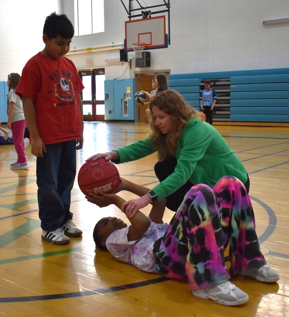students and teacher in physical education class