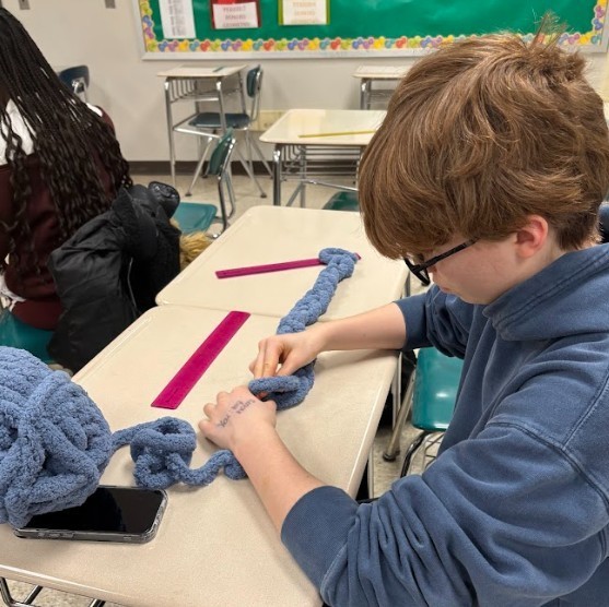 student making scarf