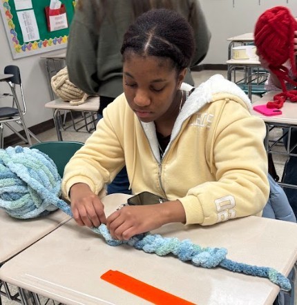 student making scarf