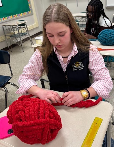 student making scarf