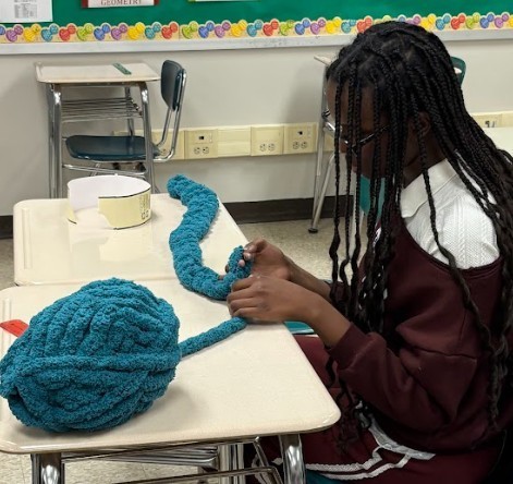 student making scarf