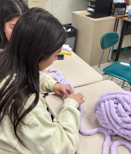 student making scarf