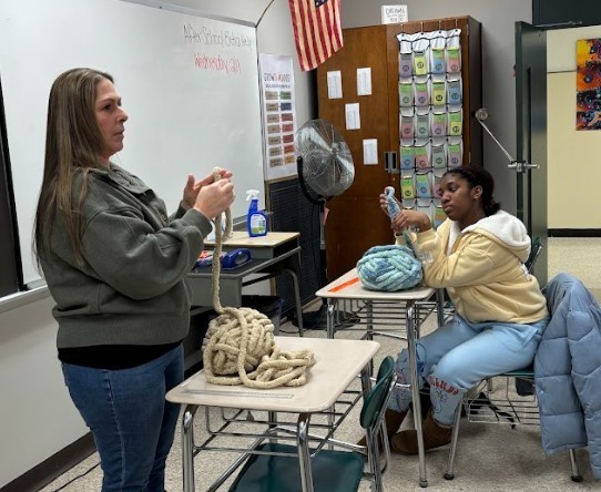 teacher and student making scarve