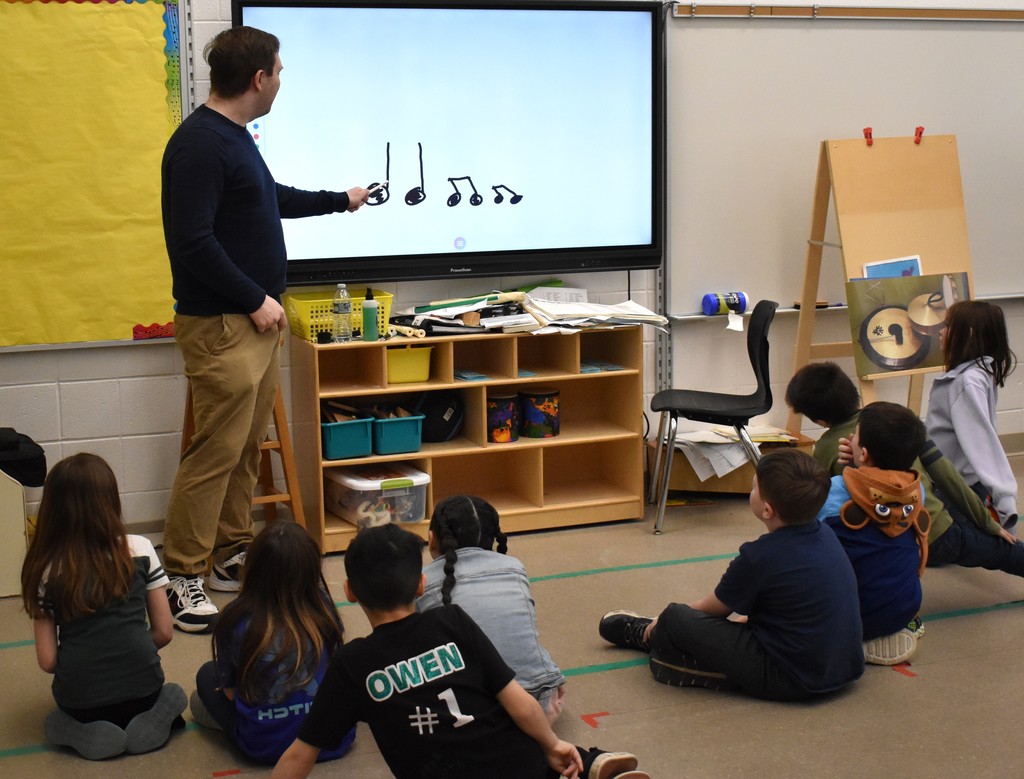 teacher with music students