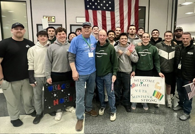 students with vet at airport