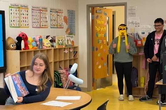 student reading to others