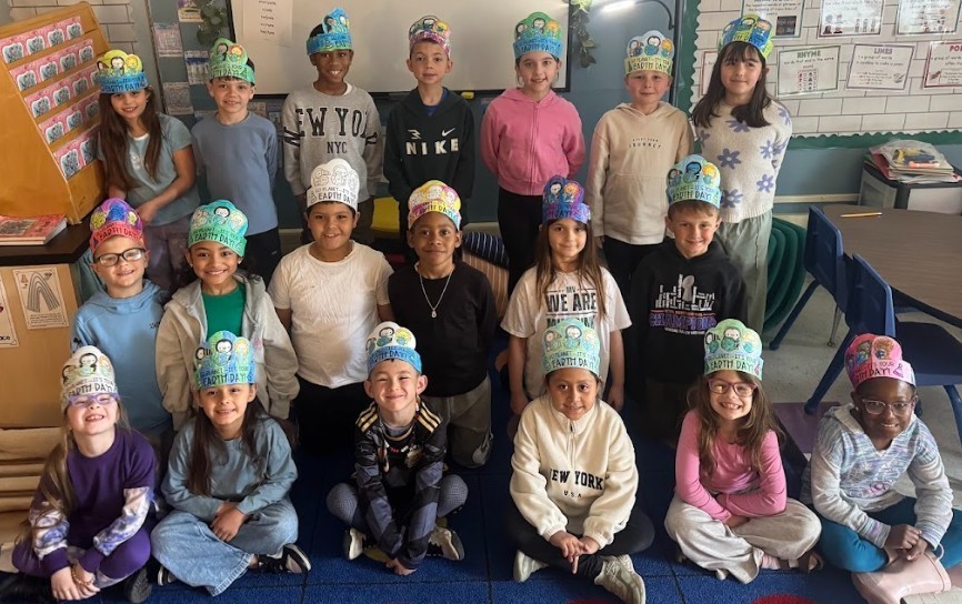 students with Earth day hats