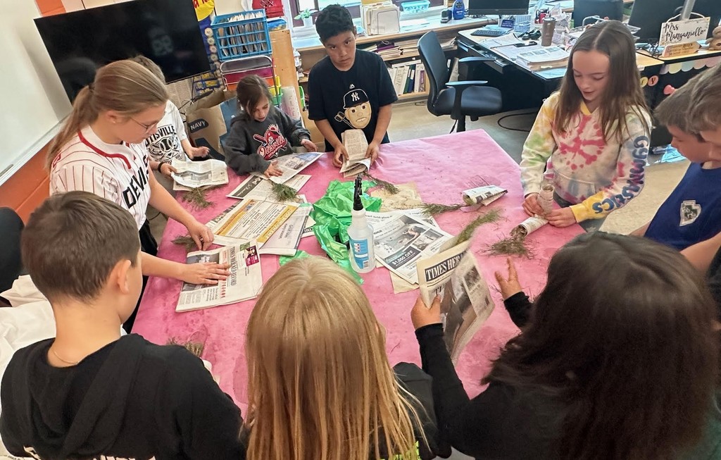 students with baby trees