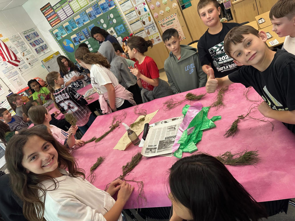 students with baby trees