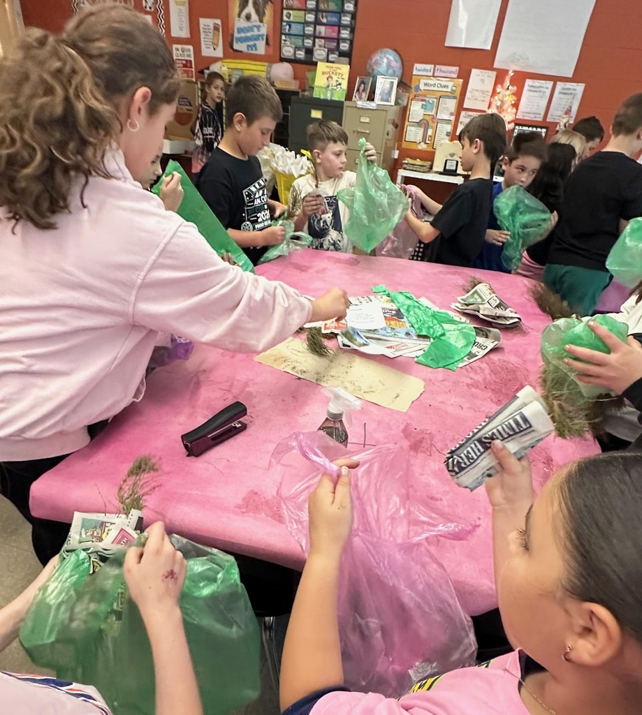 students with baby trees