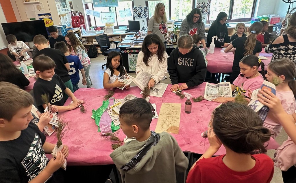 students with baby trees