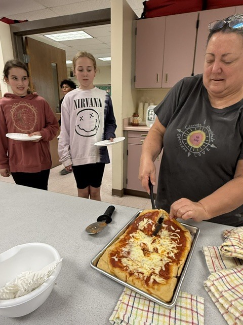 student and teacher with pizza