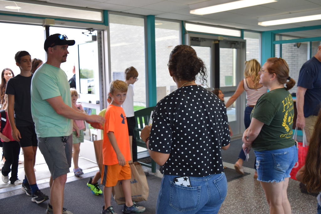 entering building with school supplies