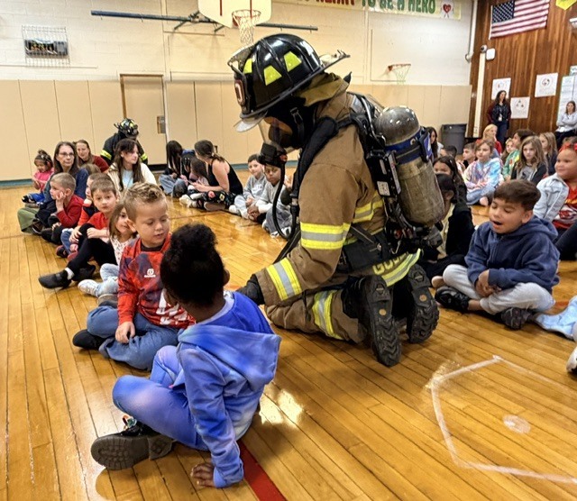 students with firefighters