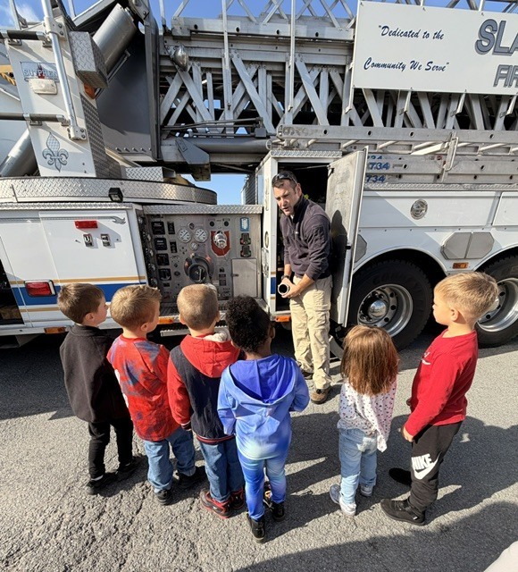 students with firefighters