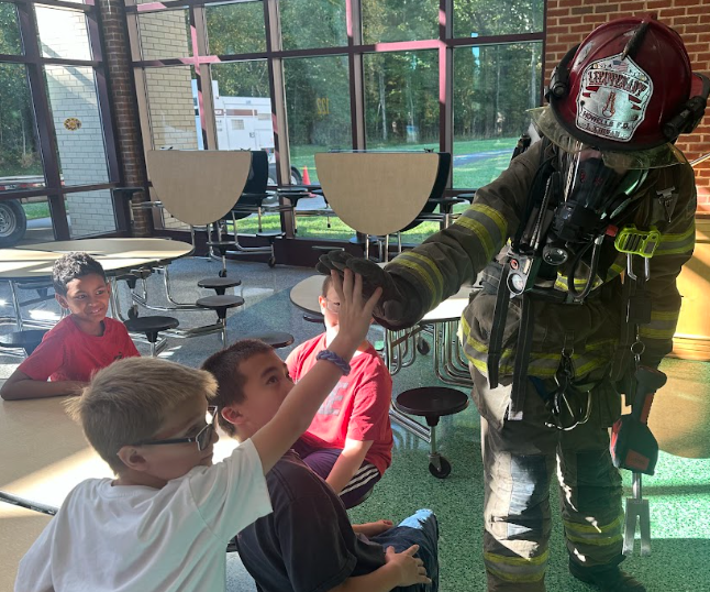 students with firefighters