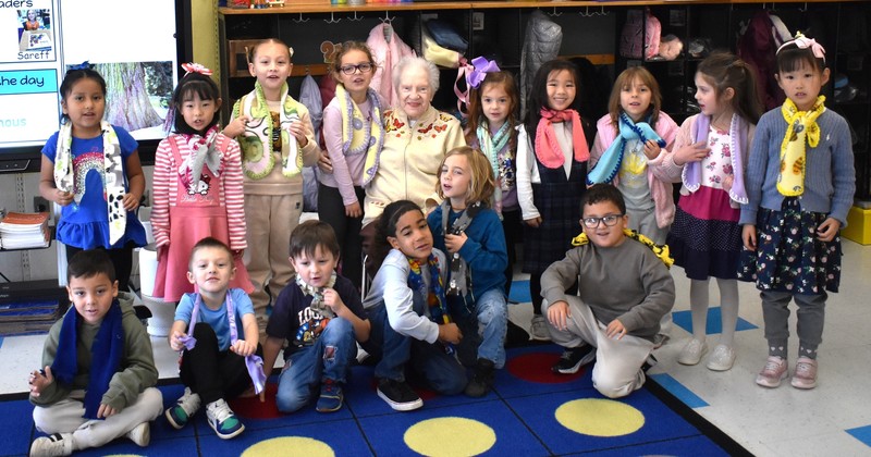 students in classroom with elderly lady