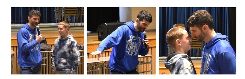 speaker with student at assembly