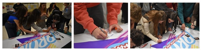 students signing banner