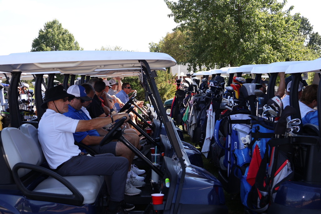 Golfers sitting in their carts, ready to go.