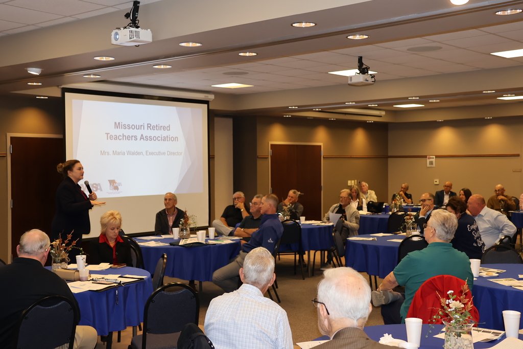 Zoomed out view of the room full of people, listening as Maria Walden, MRTA, gives her presentation.