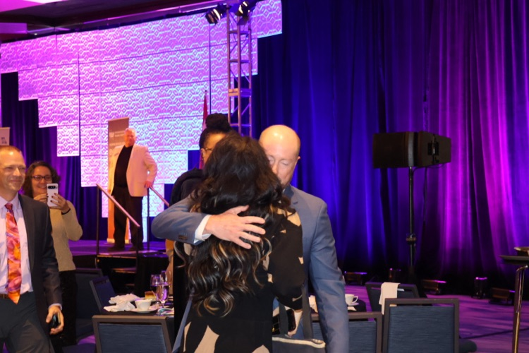 Travis bracht hugging his wife, Kelly 