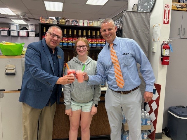 Mark and Ryan with a student holding smoothies