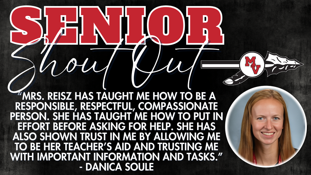 Girl smiling at camera with gray background.