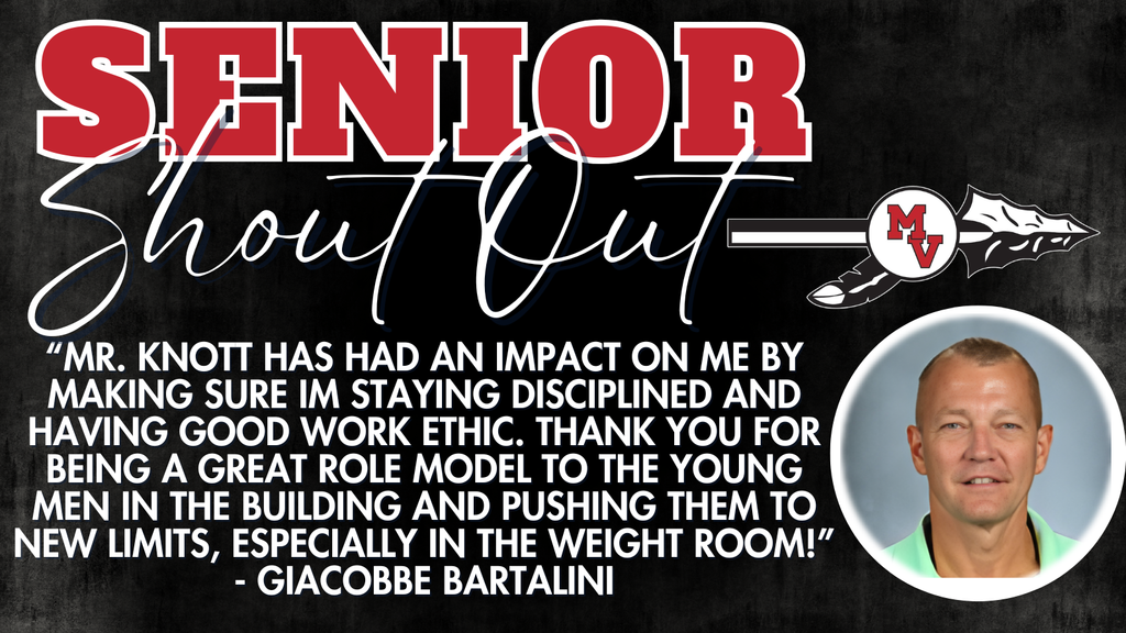 Man with green shirt smiling at the camera. 