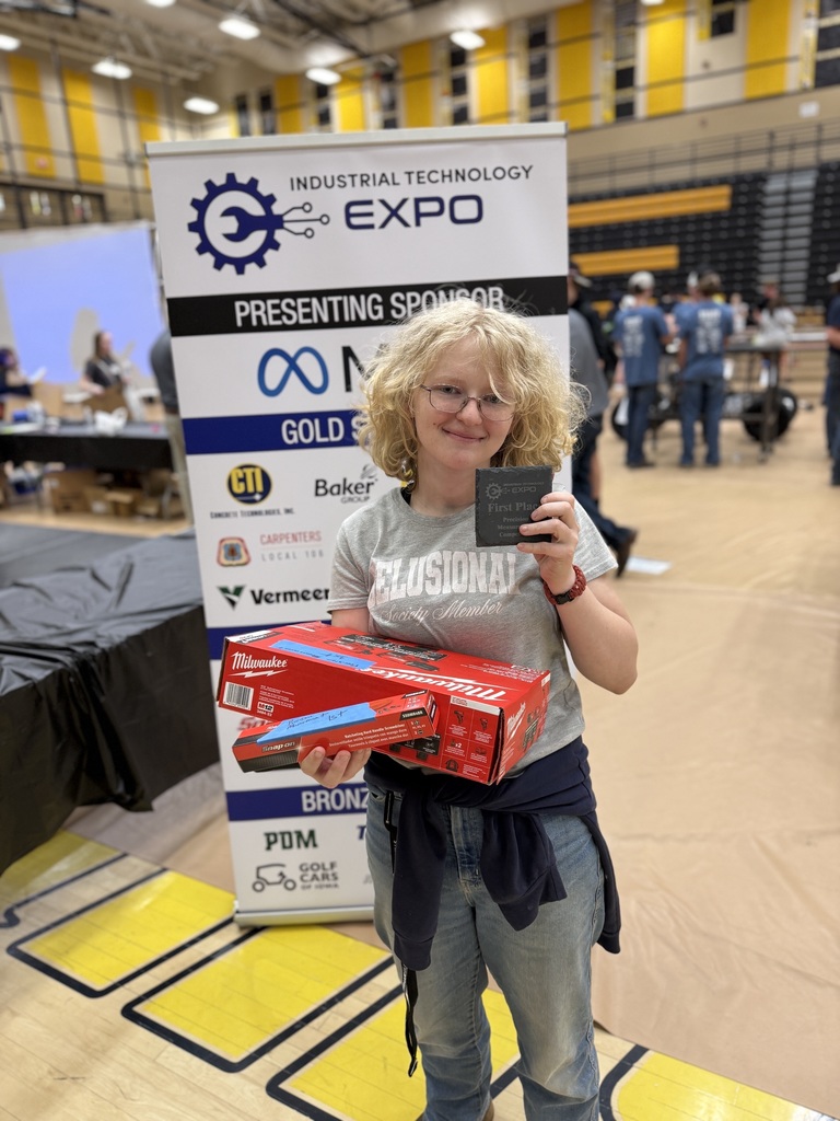 Student holding up box and award.
