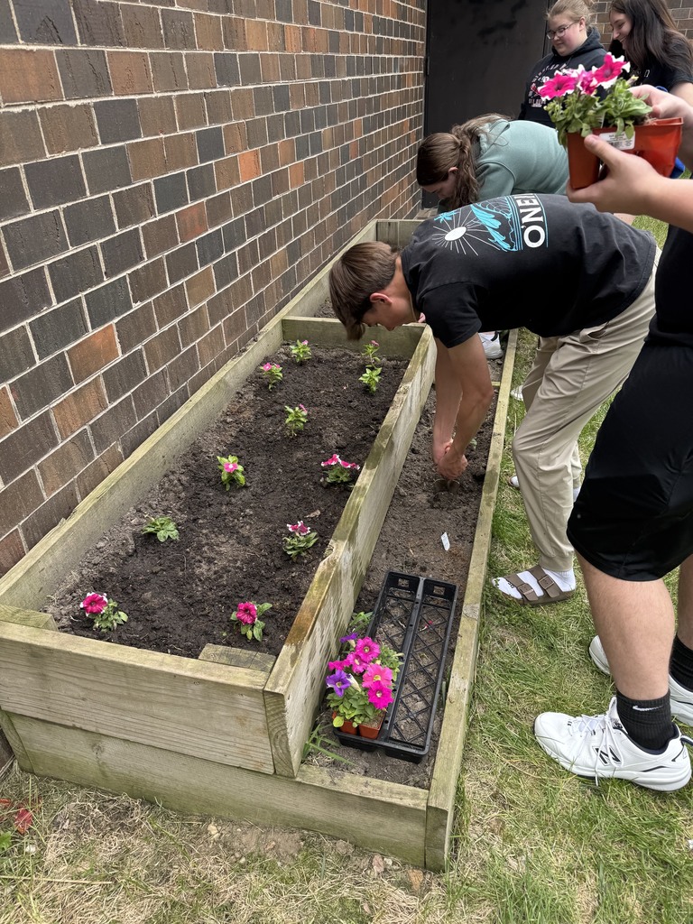 Students planting flowers.