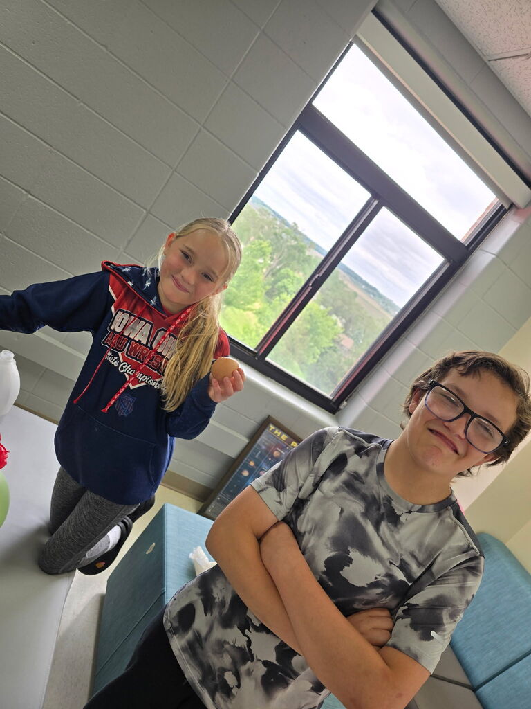 Two students working with an egg.