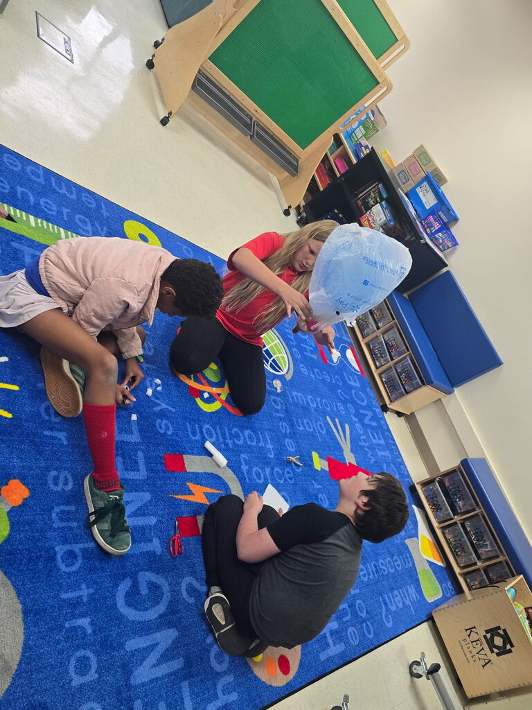 Three students working with a bag.