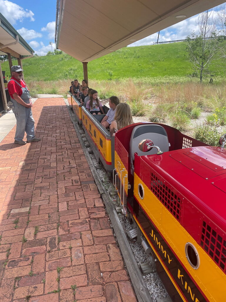 Kids sitting in a small train.