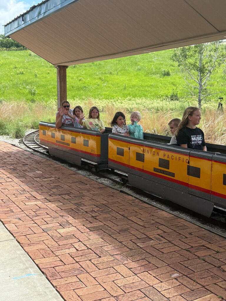 Kids sitting in a small train.