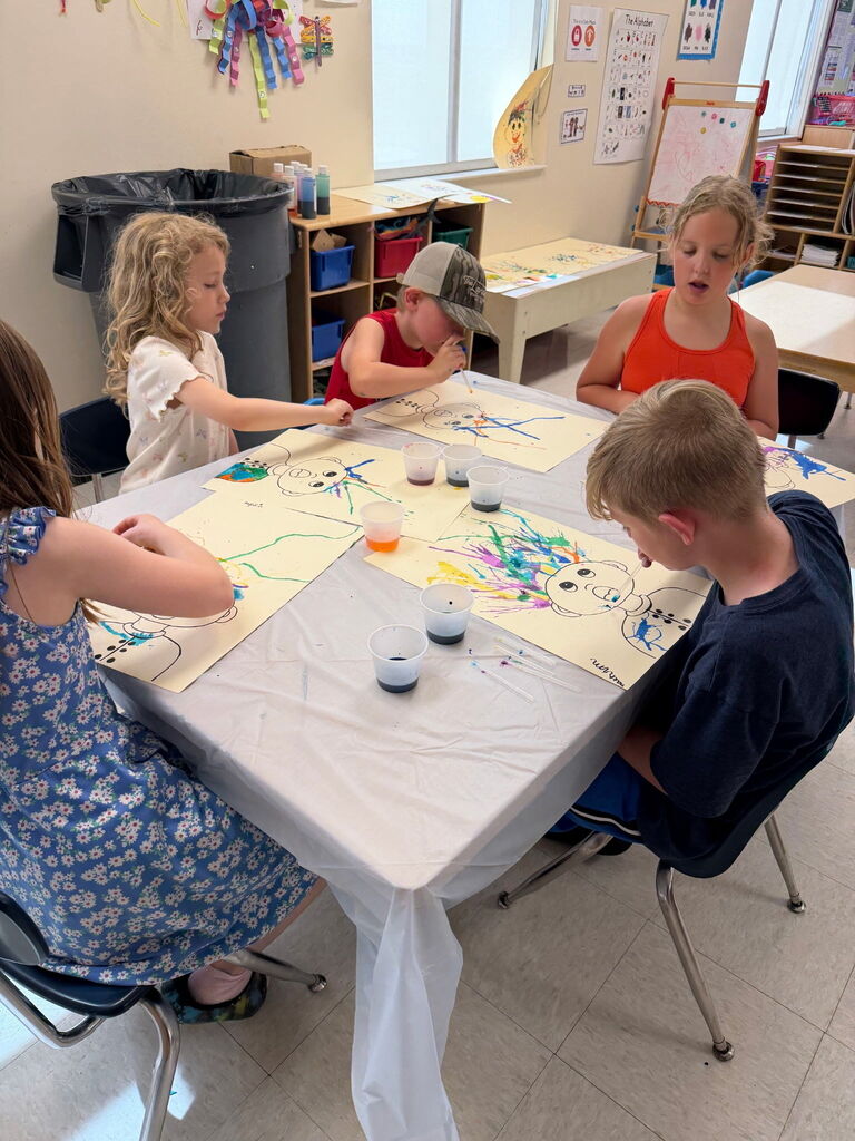 Five kids working at a table