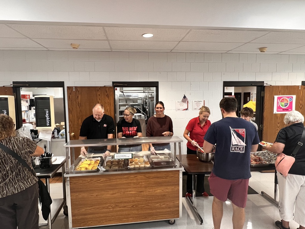 Board members serving breakfast to staff