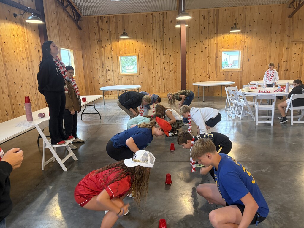 Students bending over playing a game.