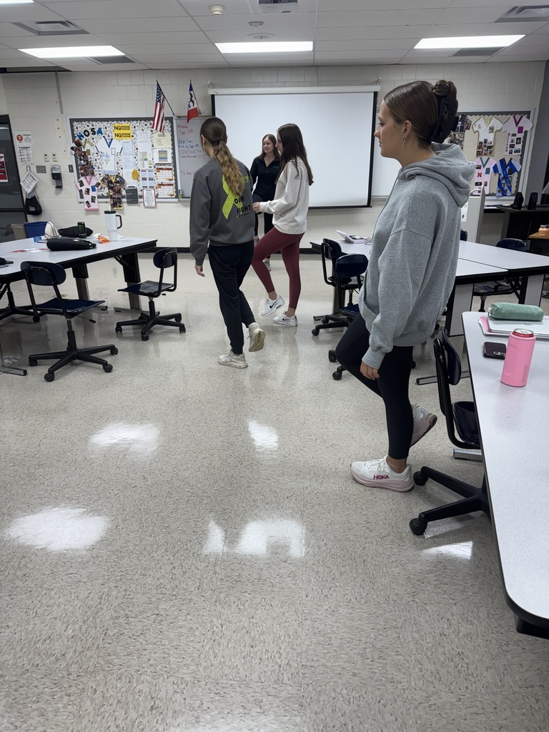 Students move around the classroom during an instructor-led group activity.