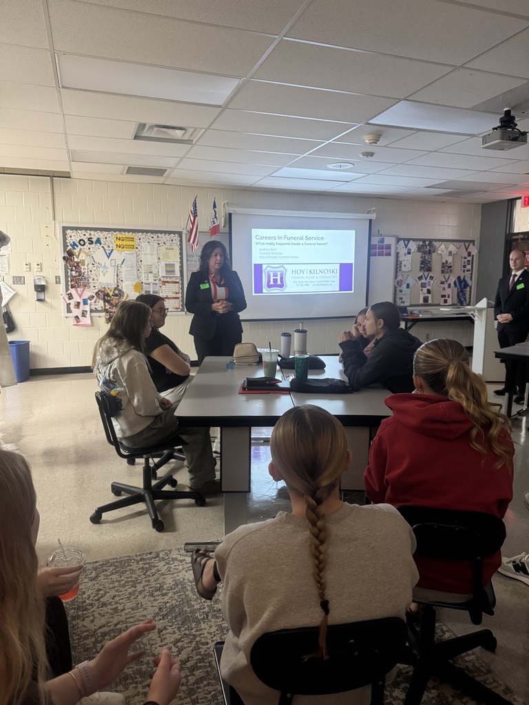 Funeral service professionals from Høy-Kilnoski Funeral Home discuss careers in funeral service with students during a classroom presentation.