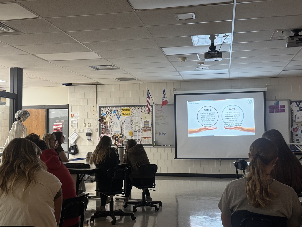 Students watch a QPR presentation explaining myths and facts about asking someone directly about suicide.