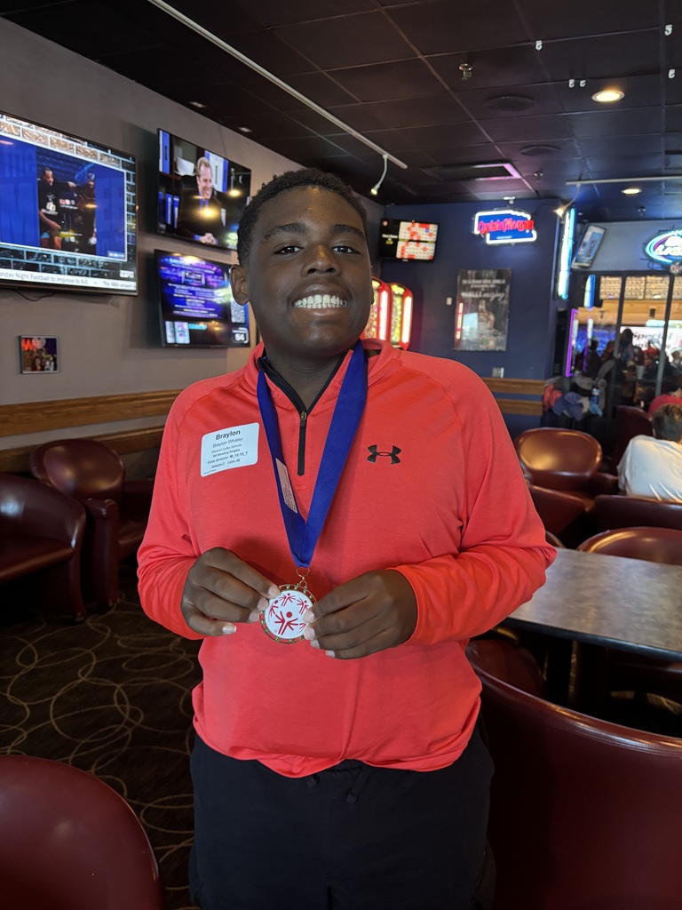 Child with medal around their neck
