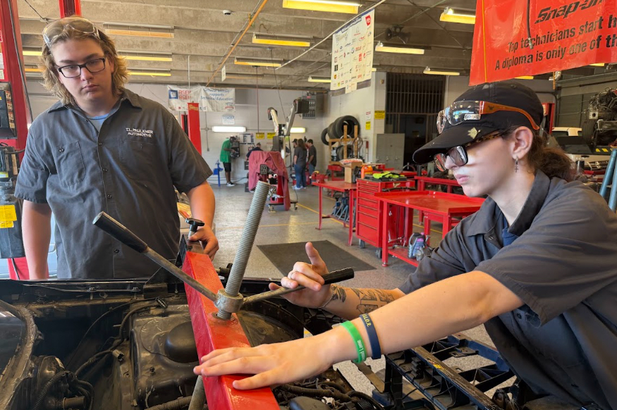 2 automotive students working on vehicle
