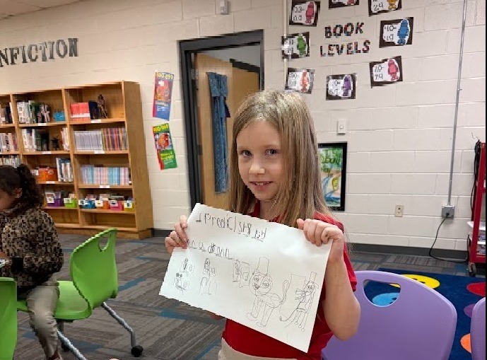 girl holding up prediction in the library