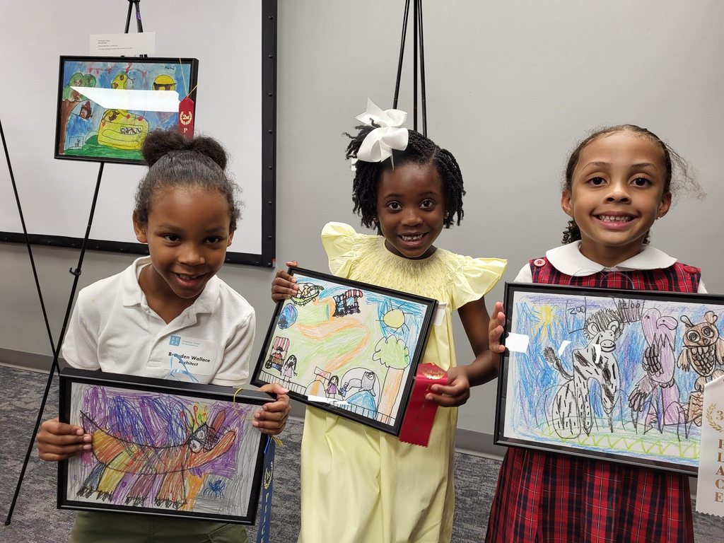 Students holding their artwork during dreamARCHITECTURE reception